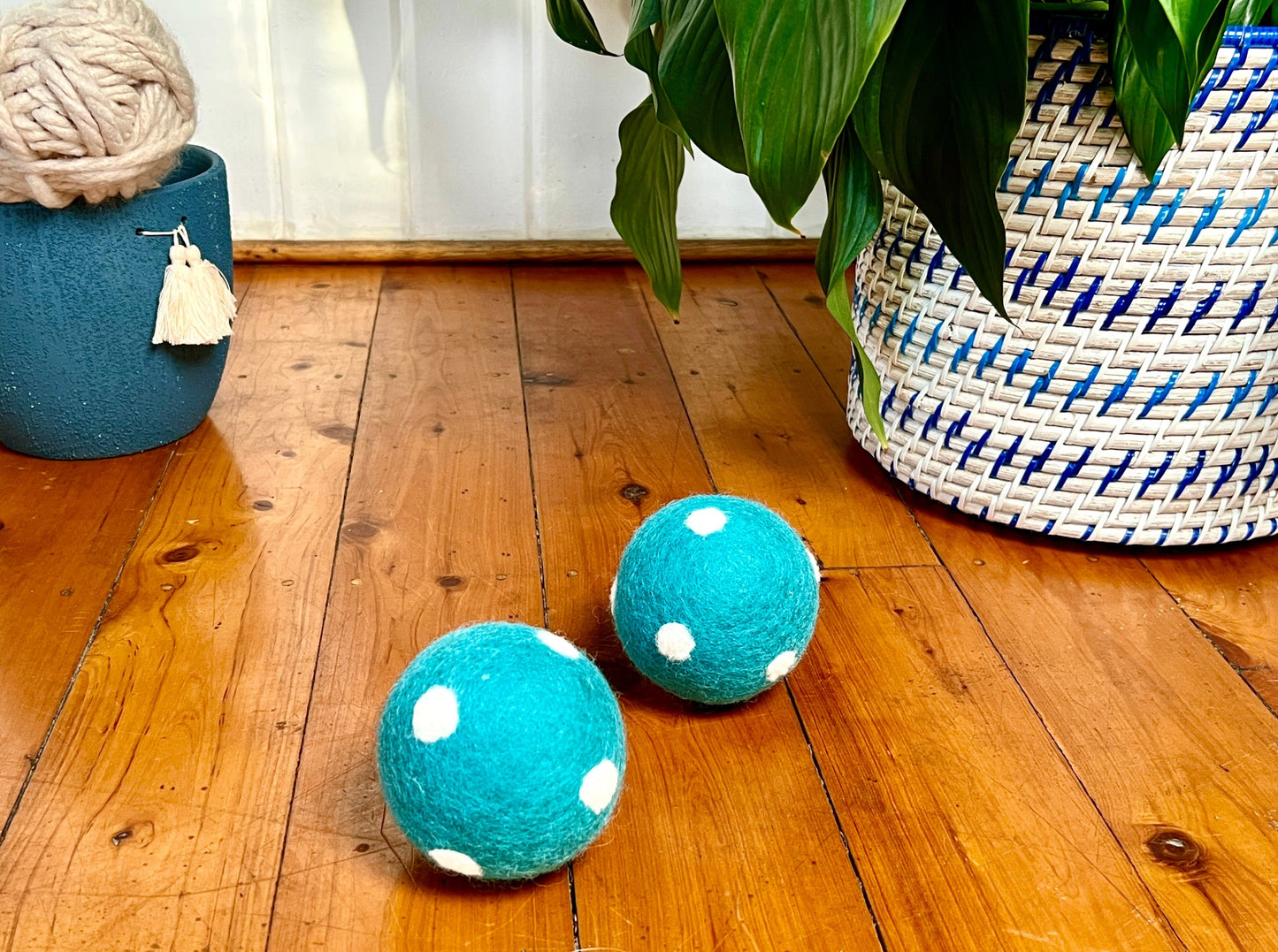 Dog Toys - beautiful blue felt balls with white dogs, on a wooden floor. Perfect soft dog toy for indoor play.