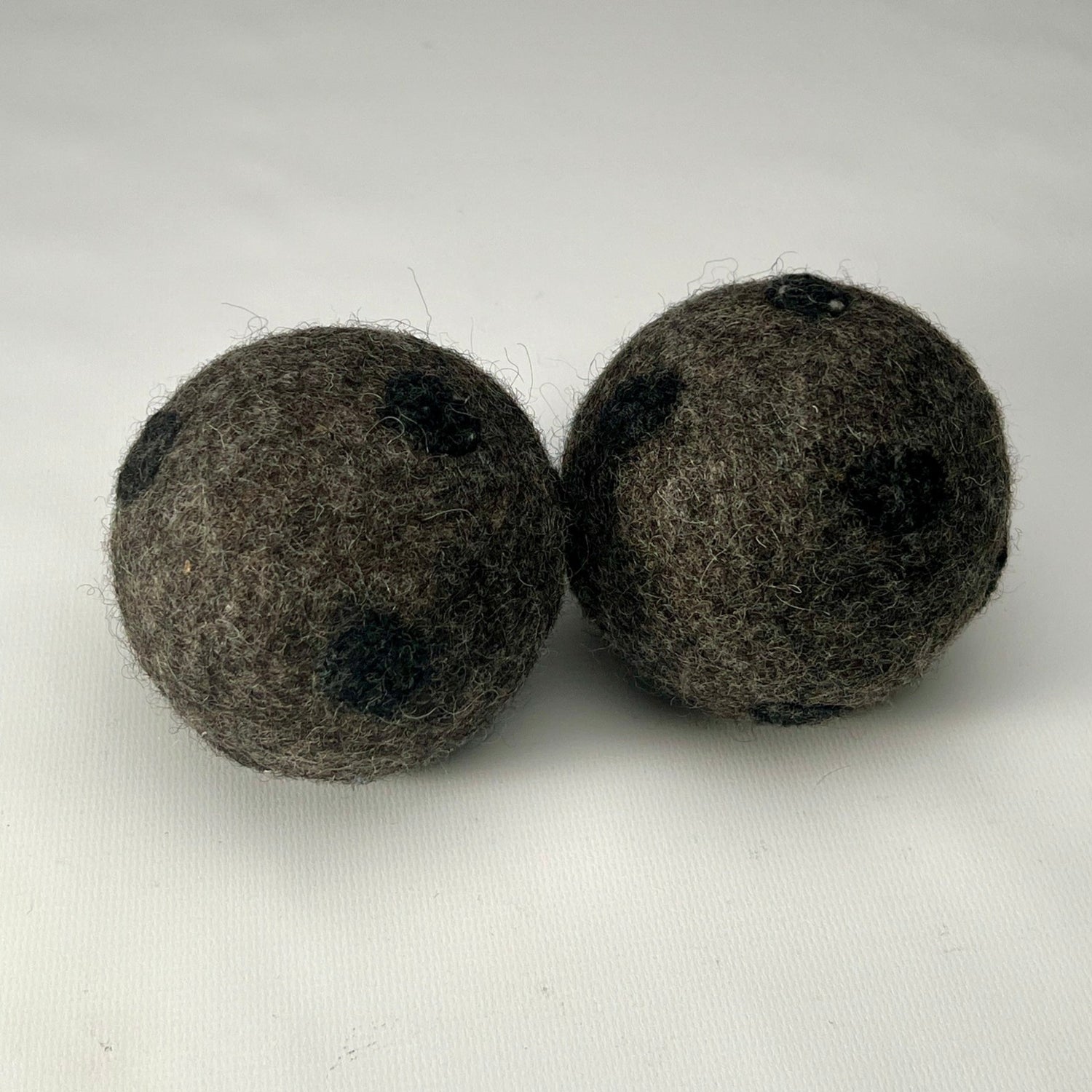 Dog Toys - two large, soft felt indoor catch balls for dogs. Grey woolen colour with black polka dots catchballs